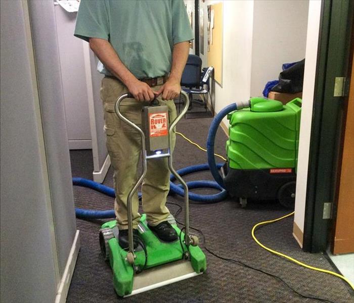 SERVPRO tech extracting water from a carpet in Dunwoody, GA