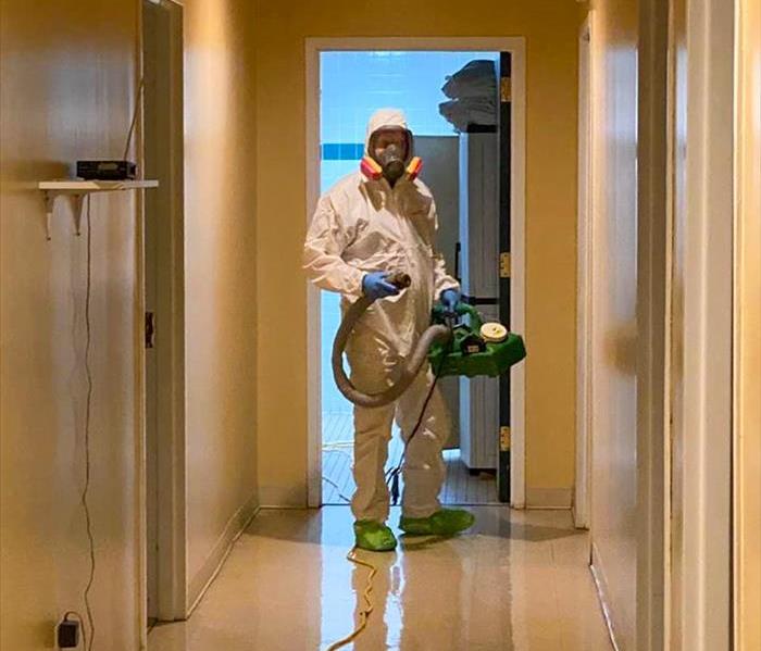 SERVPRO tech in PPE cleaning a bathroom in Brookhaven, GA